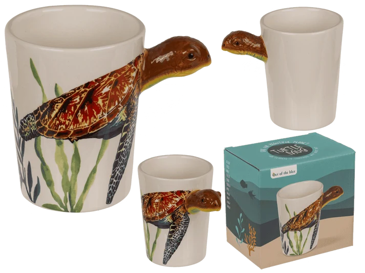 Taza original blanca con ilustración de tortuga marina y asa 3D en forma de tortuga, acompañada de caja decorada
