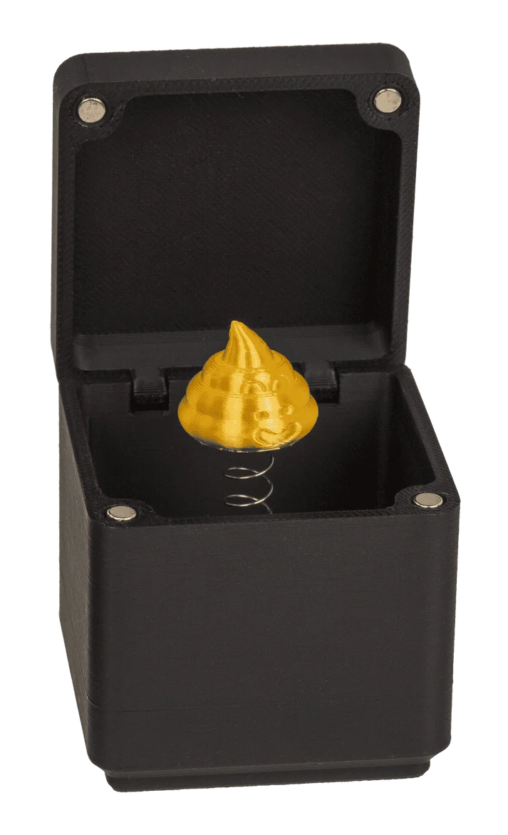 Caja regalo sorpresa con dedo corazón dorado que salta al abrirse