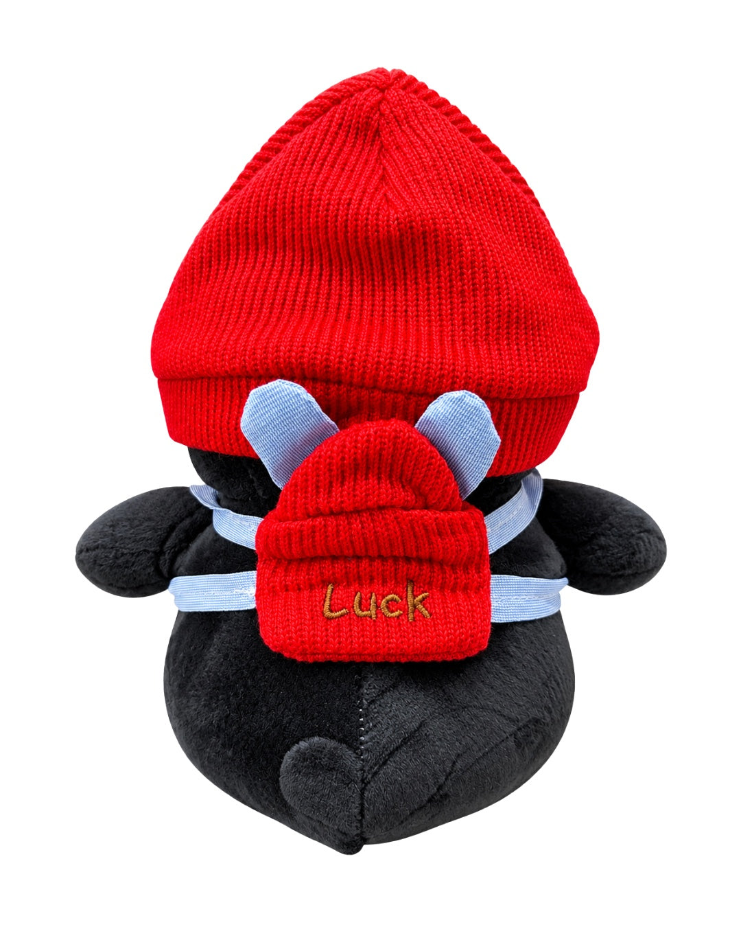 Vista trasera del pingüino con gorro rojo y mochila